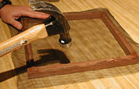 Carefully hammer staples so they are flush with wood