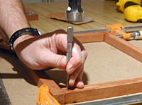 Making pilot hole for drill using a nail set